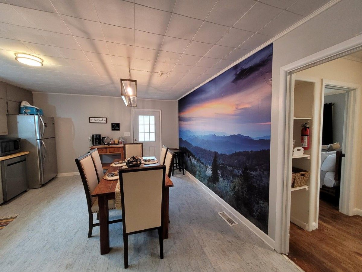 Beautiful mountain scene frames the backdrop in this rentals dining room.